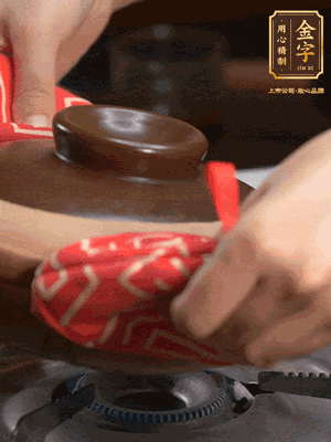 中火調成小火，鋪上香腸蓋蓋燜5分鐘。不斷轉動瓦煲，讓側壁的飯形成飯焦